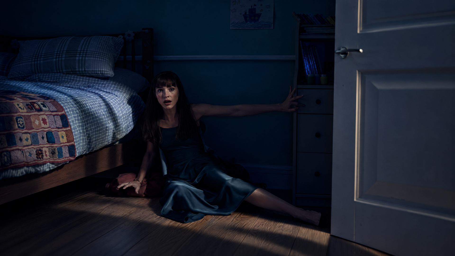4K Ultra HD Other Mommy wallpaper: a woman sits on the bedroom floor beside a bed, reaching toward an open door in a dark room.