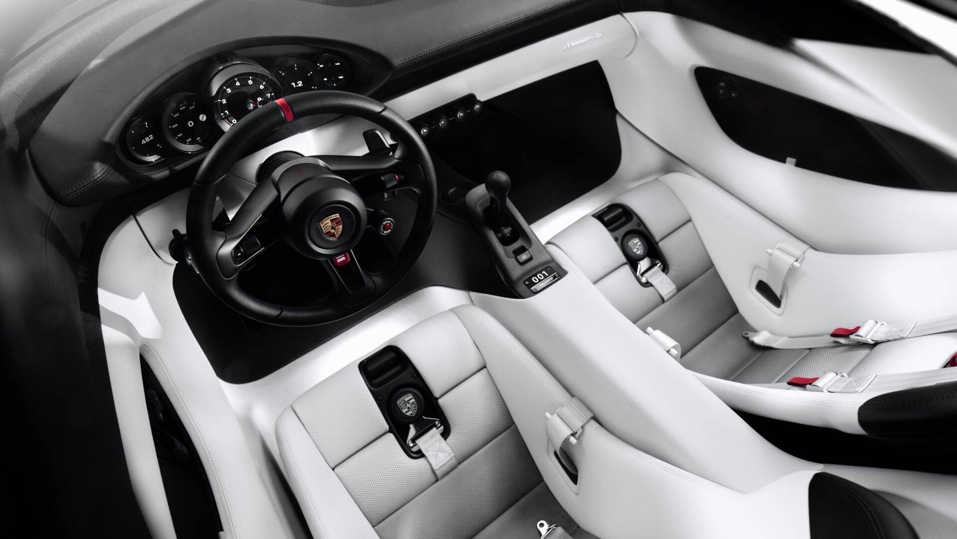 5K Ultra HD Porsche Mission S desktop wallpaper showing a futuristic white car interior with a black steering wheel and digital controls.