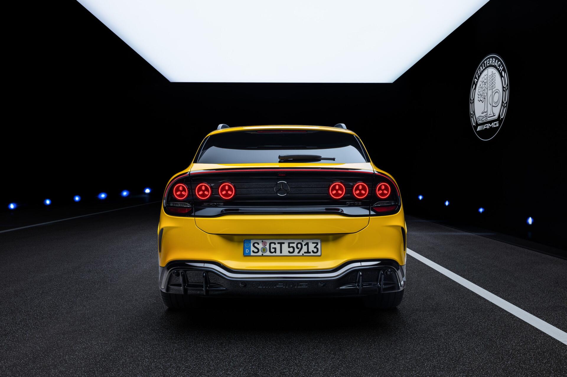 Yellow Mercedes-AMG GT SUV sports car viewed from the rear in a dark tunnel, 2K Quad HD desktop wallpaper and background.