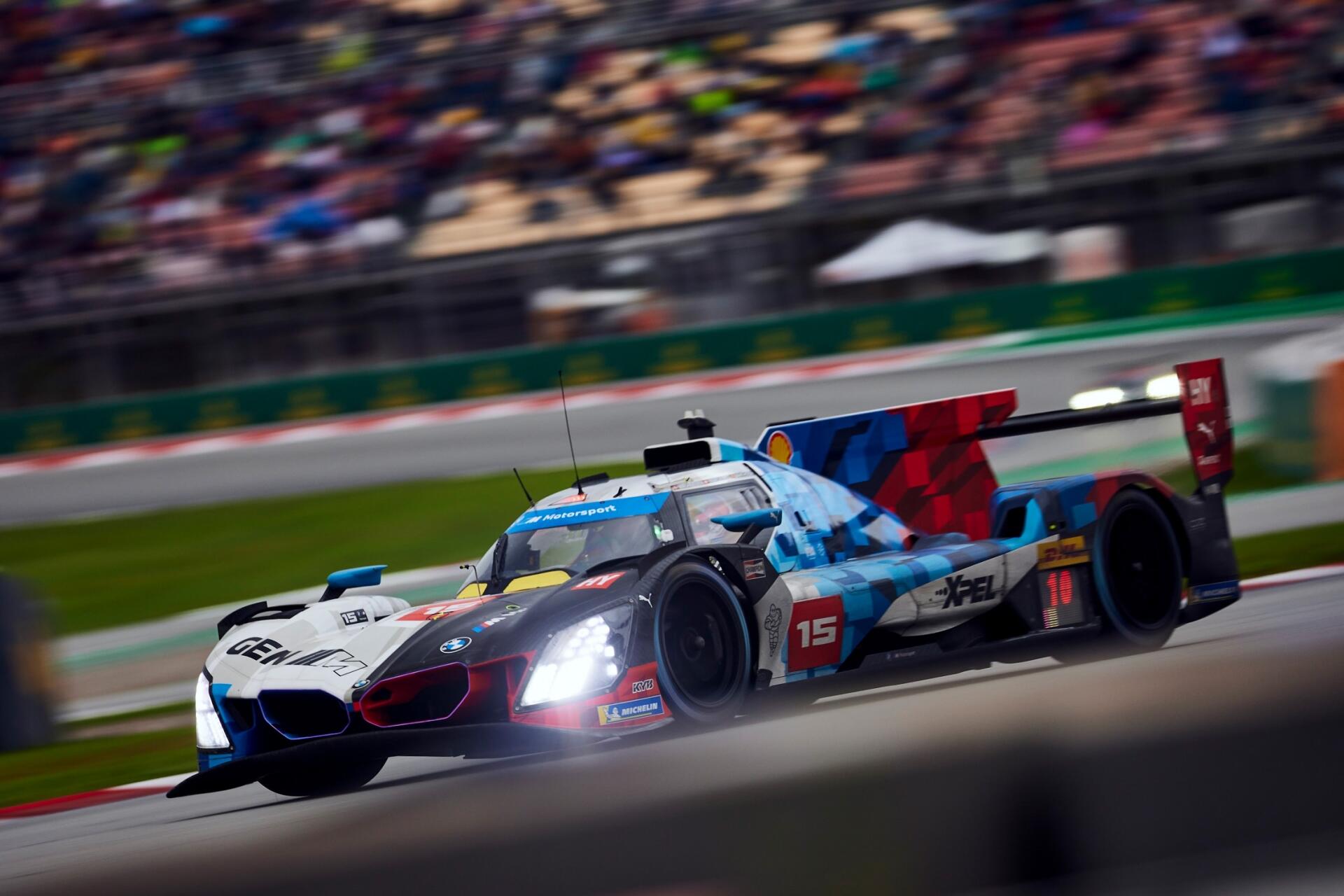 BMW M Hybrid V8 race car speeding past the grandstands in the FIA World Endurance Championship, HD desktop wallpaper.