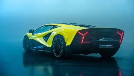 Yellow Lamborghini Fenomeno on a reflective wet floor with blue haze, rear three-quarter view — 2K Quad HD PC desktop wallpaper/background.