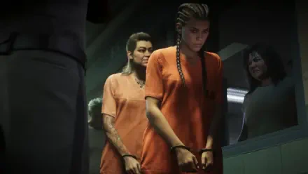 4K Ultra HD PC desktop wallpaper: Grand Theft Auto VI scene showing Lucia Caminos in an orange jumpsuit, handcuffed and escorted through a dim prison corridor (video game background).