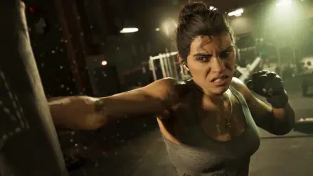 Lucia Caminos from the video game Grand Theft Auto VI throws a punch in a gritty gym, intense expression and boxing gloves — 4K Ultra HD PC desktop wallpaper background.