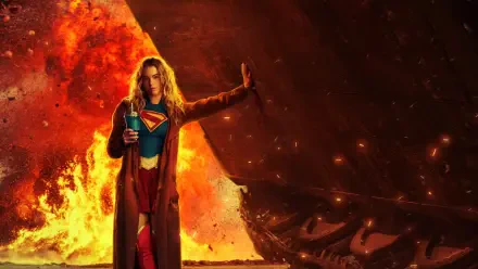 Supergirl (2026) 4K Ultra HD PC desktop wallpaper and background: Supergirl in costume and cape stands before blazing inferno and shattered wreckage, emblem glowing.