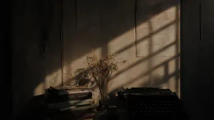 Poetcore 4K Ultra HD PC desktop wallpaper and background: moody study corner with stacked books, vintage typewriter and dried bouquet lit by window shadows.