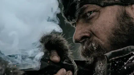 Close-up of a frost-bitten bearded frontiersman from The Revenant lighting a pipe amid snow — 4K Ultra HD PC desktop wallpaper/background.