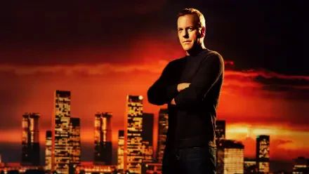 24 4K Ultra HD PC desktop wallpaper/background: stoic man in black sweater stands with arms crossed before a glowing orange city skyline at sunset.
