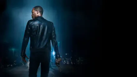 24: Legacy — 4K Ultra HD PC desktop wallpaper: lone man in a leather jacket, back to viewer, holding a handgun, bathed in cool blue city lights against a dark urban skyline.