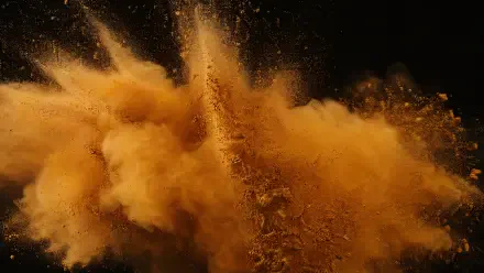 Ochre powder explosion cloud billowing against a black backdrop — dramatic 4K Ultra HD PC desktop wallpaper/background.