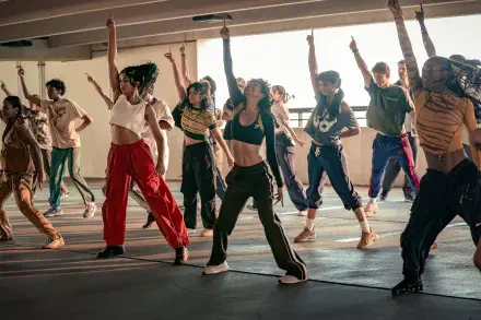 Ensemble of dancers mid-movement in a sunlit studio for Best of the Best — vibrant group dance captured as a 2K Quad HD PC desktop wallpaper.