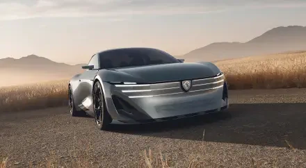 Peugeot RCZ Vision electric concept car on a desert road, shown in HD desktop wallpaper.
