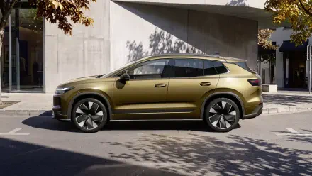 Volkswagen ID. Tiguan electric station wagon parked by modern architecture, 4K Ultra HD PC desktop wallpaper and background.