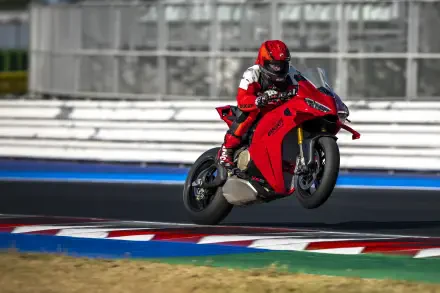 Ducati Panigale V4 and motorcycle racer speeding around a racetrack in 5K Ultra HD desktop wallpaper.