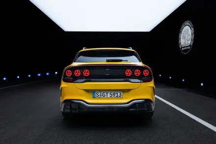 Yellow Mercedes-AMG GT SUV sports car viewed from the rear in a dark tunnel, 2K Quad HD desktop wallpaper and background.