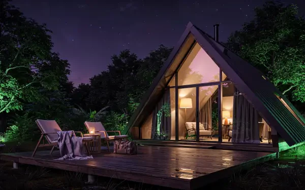 Nighttime A-frame cabin with warm interior lights, deck chairs and fire pit on a wooden platform by the trees—weekend getaway 4K Ultra HD PC desktop wallpaper and background.