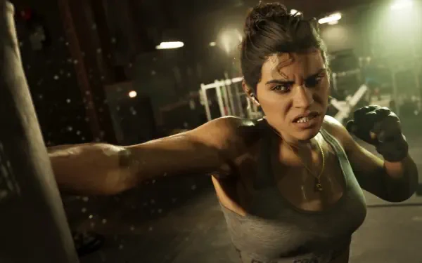 Lucia Caminos from the video game Grand Theft Auto VI throws a punch in a gritty gym, intense expression and boxing gloves — 4K Ultra HD PC desktop wallpaper background.