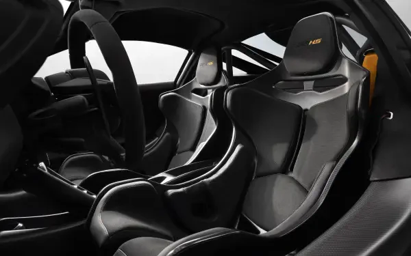 8K Ultra HD PC wallpaper of McLaren 788HS cockpit: carbon-fiber racing seats, sculpted center console and racing steering wheel in matte black and grey.