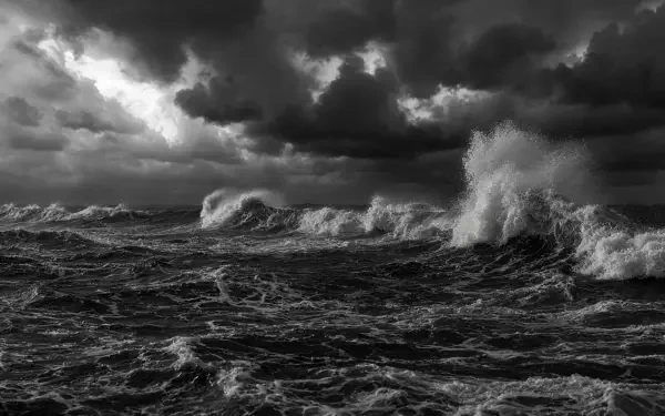 5K Ultra HD PC desktop wallpaper: stormy sea in monochrome — towering breakers, churning dark water and dramatic, brooding clouds, spray and motion under a tempestuous sky.
