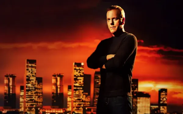 24 4K Ultra HD PC desktop wallpaper/background: stoic man in black sweater stands with arms crossed before a glowing orange city skyline at sunset.