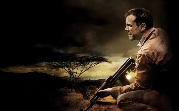 24 — 4K Ultra HD PC Desktop Wallpaper and Background: crouching man holding a rifle against a dusky African savanna, dramatic clouds and warm backlight.