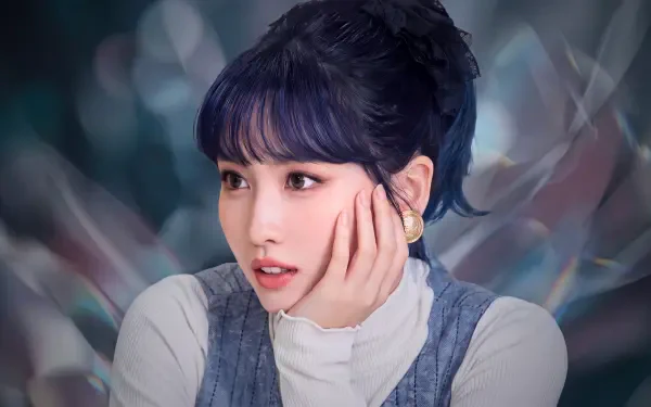 5K PC desktop wallpaper: close-up portrait of a K-pop idol–styled singer/model with dark blue hair, hand to cheek, and a soft bokeh background.