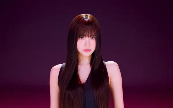 5K desktop wallpaper: studio portrait of a young woman with long dark hair and blunt bangs in a black top, centered against a deep magenta background.
