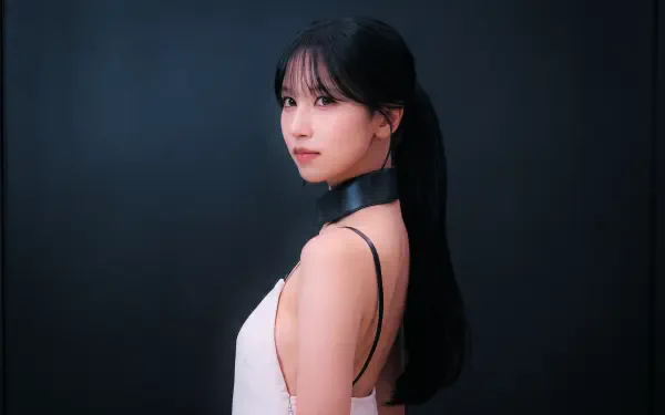 Close-up portrait of a woman with a long black ponytail in a white sleeveless top and black choker, posed against a dark backdrop — 5K PC desktop wallpaper.