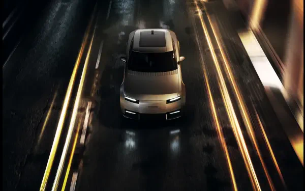 Jaguar Type 01 driving along a rain-slick road at night, 8K Ultra HD PC desktop wallpaper and background.