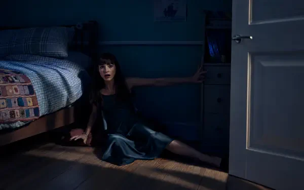 4K Ultra HD Other Mommy wallpaper: a woman sits on the bedroom floor beside a bed, reaching toward an open door in a dark room.