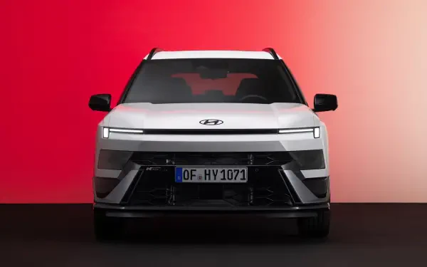 Front view of a Hyundai Bayon electric SUV against a red backdrop, featured in an 8K Ultra HD desktop wallpaper.