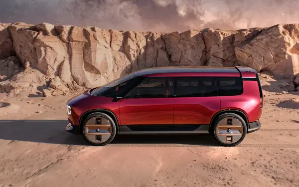 Red Renault E-Space electric SUV against desert cliffs, featured in an HD PC desktop wallpaper background.