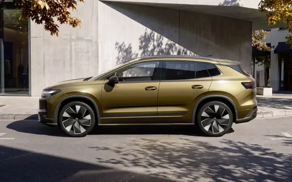 Volkswagen ID. Tiguan electric station wagon parked by modern architecture, 4K Ultra HD PC desktop wallpaper and background.