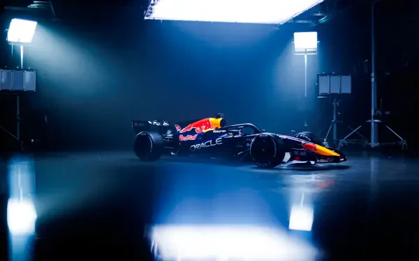 Red Bull Racing RB22 Formula One race car in a dramatic blue-lit studio, featured in a 4K Ultra HD PC desktop wallpaper and background.