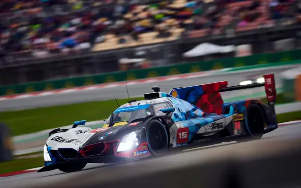 BMW M Hybrid V8 race car speeding past the grandstands in the FIA World Endurance Championship, HD desktop wallpaper.