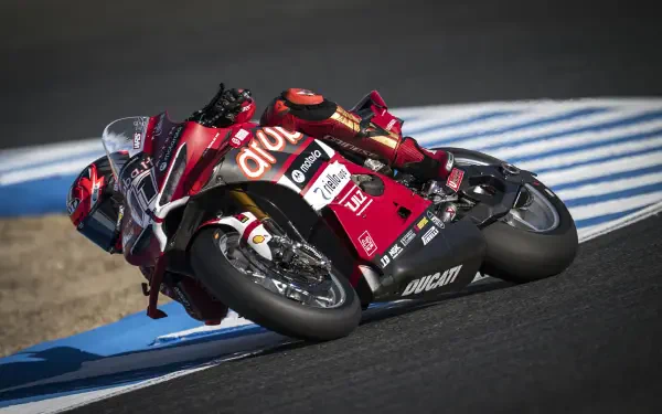 Ducati Panigale V4 R motorcycle racing through a circuit corner, HD desktop wallpaper and background