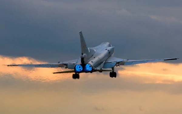 Military Tupolev Tu-22 bomber captured in flight against a dramatic sunset sky, presented as a high-definition PC desktop wallpaper and background.