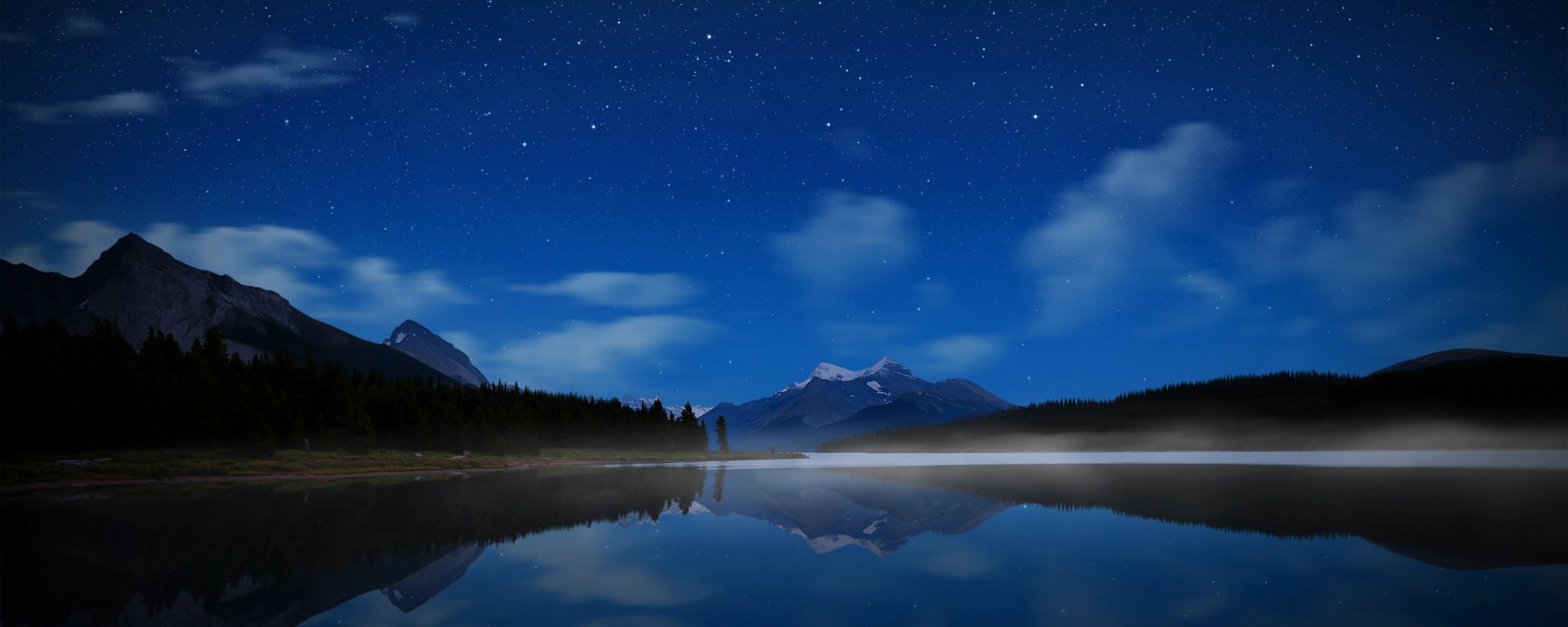 HD PC desktop wallpaper of a serene lake reflecting mountains under a starry night sky, showcasing peaceful nature and clear night reflections.