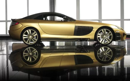 Gold Mercedes-Benz SLR McLaren sports car in profile with mirrored reflection on a glossy floor, showcased against tall windows — HD PC desktop wallpaper.