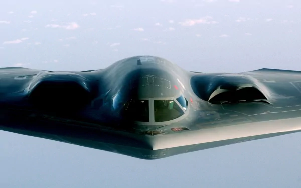 A high-definition wallpaper featuring a stealth military aircraft soaring through the sky, showcasing its sleek design and advanced engineering.