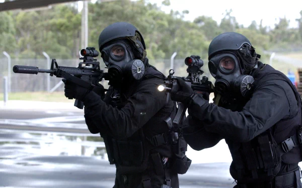 Two Special Forces soldiers in tactical gear and gas masks aim rifles during a military operation, captured in an HD PC desktop wallpaper image.