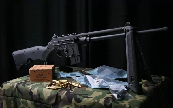 A Ruger SR-556 displayed on a camouflage surface, surrounded by ammunition boxes and cartridges, set against a dark background, creating an HD desktop wallpaper effect.