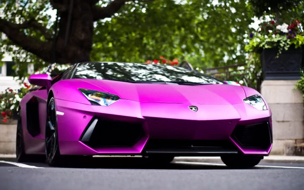 A striking Lamborghini Aventador LP 700-4 in bold purple showcases sleek lines and an aggressive stance, set against a backdrop of lush greenery.