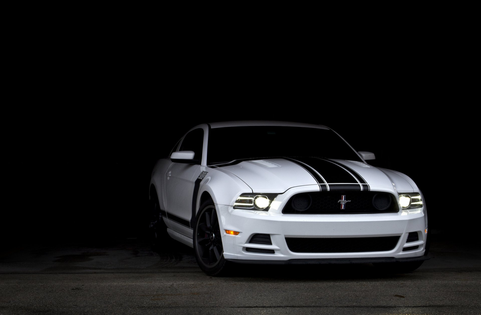 A sleek white Ford Mustang with black racing stripes is showcased against a dark background, creating a striking visual for an HD PC desktop wallpaper.