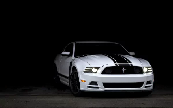A sleek white Ford Mustang with black racing stripes is showcased against a dark background, creating a striking visual for an HD PC desktop wallpaper.