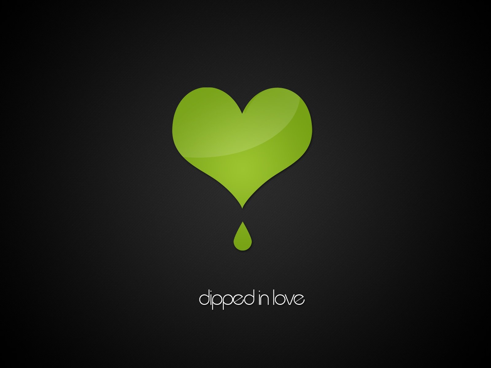 A vibrant green heart drips with love against a dark background, complemented by the text dipped in love. This artistic design serves as an inspiring HD desktop wallpaper.