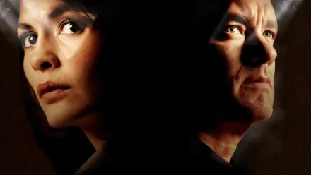 HD wallpaper of Audrey Tautou and Tom Hanks in The Da Vinci Code, featuring intense close-up portraits against a shadowy background.