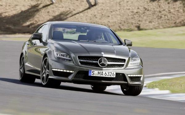 Silver Mercedes‑Benz CLS63 vehicle rounding a corner on a racetrack — HD PC desktop wallpaper background.