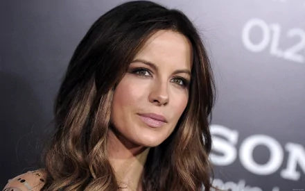 Close-up of Kate Beckinsale, showcasing her elegant features and long hair against a dark backdrop, captured as a striking HD desktop wallpaper.