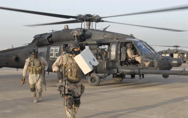 Military personnel disembark from a Sikorsky UH-60 Black Hawk helicopter in a high-resolution 4K Ultra HD desktop wallpaper and background.
