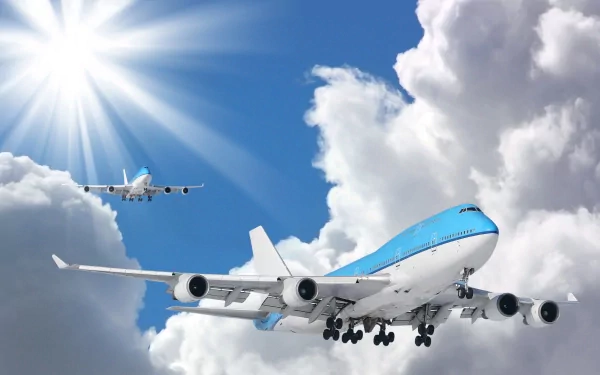 HD PC desktop wallpaper of two aircraft flying through bright, partly cloudy skies with sunlight streaming in the background.